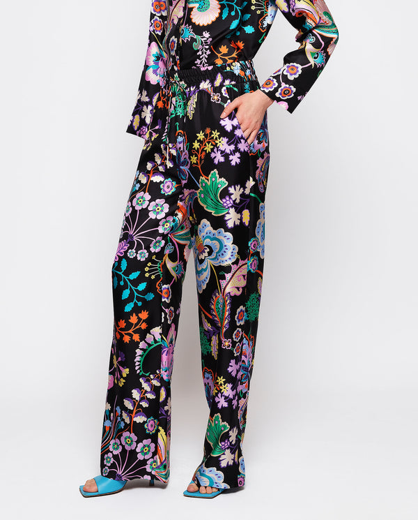 Black silk floral print trousers by MIRTO