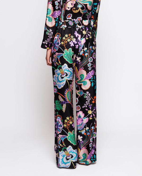 Black silk floral print trousers by MIRTO